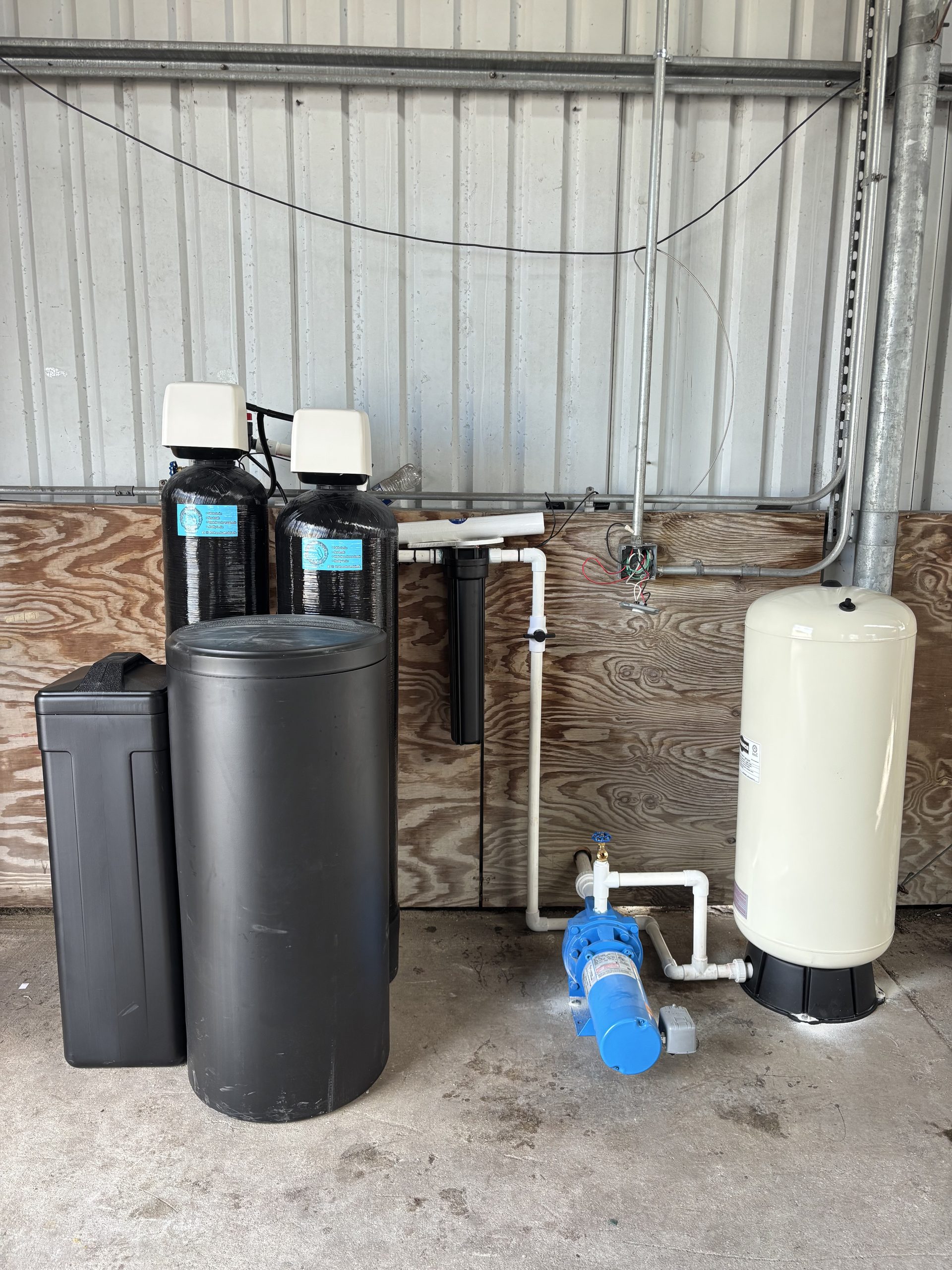 Advanced Water Solutions team installing a dual water softener system in Jupiter, FL